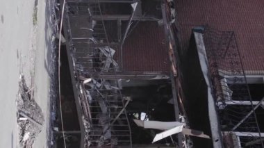 This stock vertical video shows a destroyed building in the city of Makariv during the war in Ukraine, grey, flat video