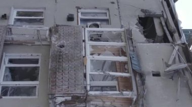 This stock vertical video shows a destroyed building in the city of Makariv during the war in Ukraine, grey, flat video