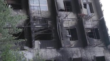 This stock vertical video shows a destroyed building in the city of Makariv during the war in Ukraine, grey, flat video
