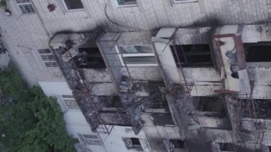 This stock vertical video shows a destroyed building in the city of Makariv during the war in Ukraine, grey, flat video
