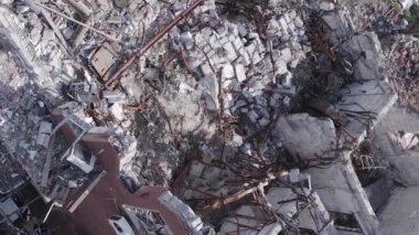 This stock vertical video shows a destroyed building in the city of Makariv during the war in Ukraine, grey, flat video