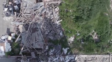 This stock vertical video shows a destroyed building in the city of Makariv during the war in Ukraine, grey, flat video