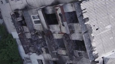 This stock vertical video shows a destroyed building in the city of Makariv during the war in Ukraine, grey, flat video