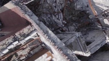 This stock vertical video shows a destroyed building in the city of Makariv during the war in Ukraine, grey, flat video