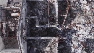 This stock vertical video shows a destroyed building in the city of Makariv during the war in Ukraine, grey, flat video