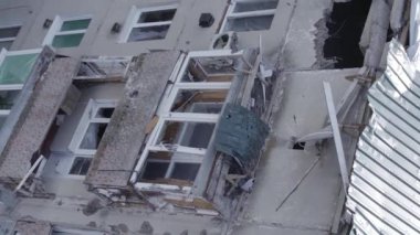 This stock vertical video shows a destroyed building in the city of Makariv during the war in Ukraine, grey, flat video