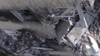 This stock vertical video shows a destroyed building in the city of Makariv during the war in Ukraine, grey, flat video
