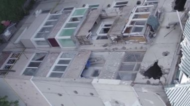 This stock vertical video shows a destroyed building in the city of Makariv during the war in Ukraine, grey, flat video