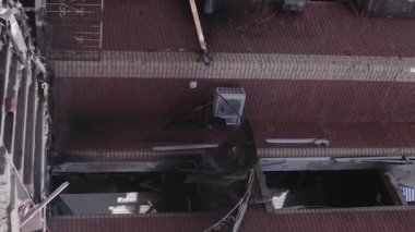 This stock vertical video shows a destroyed building in the city of Makariv during the war in Ukraine, grey, flat video