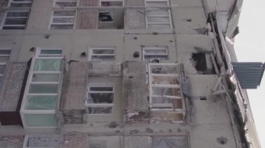 This stock vertical video shows a destroyed building in the city of Makariv during the war in Ukraine, grey, flat video