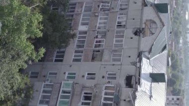 This stock vertical video shows a destroyed building in the city of Makariv during the war in Ukraine, grey, flat video