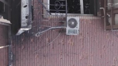 This stock vertical video shows a destroyed building in the city of Makariv during the war in Ukraine, grey, flat video