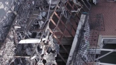 This stock vertical video shows a destroyed building in the city of Makariv during the war in Ukraine, grey, flat video