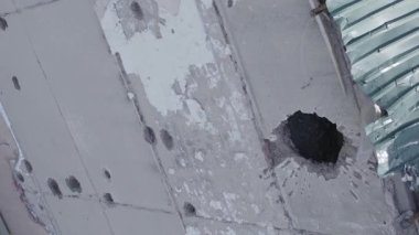 This stock vertical video shows a destroyed building in the city of Makariv during the war in Ukraine, grey, flat video