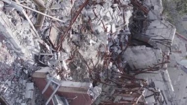 This stock vertical video shows a destroyed building in the city of Makariv during the war in Ukraine, grey, flat video