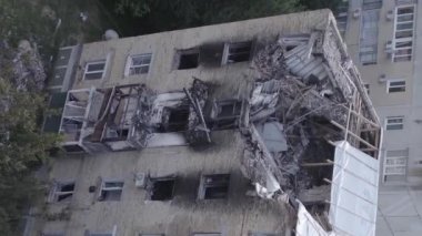 This stock vertical video shows a destroyed building in the city of Makariv during the war in Ukraine, grey, flat video