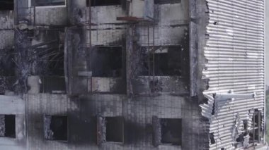 This stock vertical video shows a destroyed building in the city of Makariv during the war in Ukraine, grey, flat video