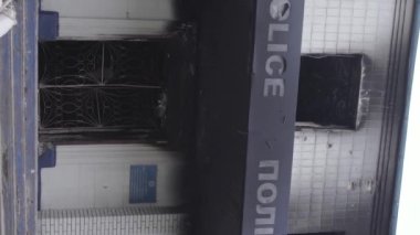 This stock vertical video shows the aftermath of the war in Ukraine - the destroyed and burned building of the police station in Borodyanka, Kyiv region, grey, flat video