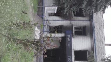 This stock vertical video shows the aftermath of the war in Ukraine - the destroyed and burned building of the police station in Borodyanka, Kyiv region, grey, flat video