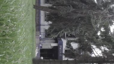 This stock vertical video shows the aftermath of the war in Ukraine - the destroyed and burned building of the police station in Borodyanka, Kyiv region, grey, flat video