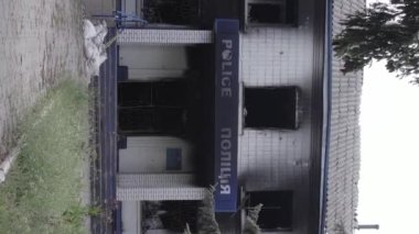 This stock vertical video shows the aftermath of the war in Ukraine - the destroyed and burned building of the police station in Borodyanka, Kyiv region, grey, flat video