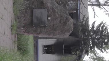 This stock vertical video shows the aftermath of the war in Ukraine - the destroyed and burned building of the police station in Borodyanka, Kyiv region, grey, flat video
