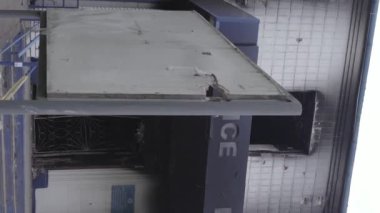 This stock vertical video shows the aftermath of the war in Ukraine - the destroyed and burned building of the police station in Borodyanka, Kyiv region, grey, flat video