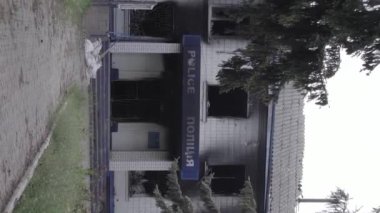 This stock vertical video shows the aftermath of the war in Ukraine - the destroyed and burned building of the police station in Borodyanka, Kyiv region, grey, flat video