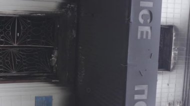 This stock vertical video shows the aftermath of the war in Ukraine - the destroyed and burned building of the police station in Borodyanka, Kyiv region, grey, flat video