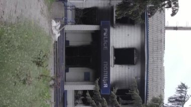 This stock vertical video shows the aftermath of the war in Ukraine - the destroyed and burned building of the police station in Borodyanka, Kyiv region, grey, flat video