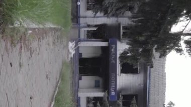 This stock vertical video shows the aftermath of the war in Ukraine - the destroyed and burned building of the police station in Borodyanka, Kyiv region, grey, flat video