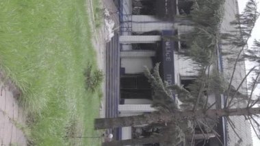 This stock vertical video shows the aftermath of the war in Ukraine - the destroyed and burned building of the police station in Borodyanka, Kyiv region, grey, flat video