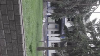 This stock vertical video shows the aftermath of the war in Ukraine - the destroyed and burned building of the police station in Borodyanka, Kyiv region, grey, flat video