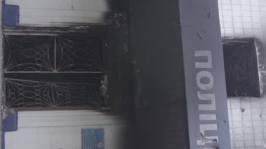 This stock vertical video shows the aftermath of the war in Ukraine - the destroyed and burned building of the police station in Borodyanka, Kyiv region, grey, flat video