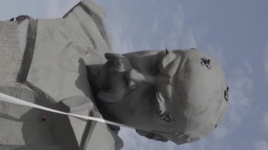 This stock vertical video shows the shot-through monument to Taras Shevchenko in Borodyanka, Ukraine during the war, flat, grey