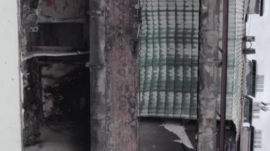 This stock vertical video shows a war-torn building in Stoyanka, Bucha district, Ukraine, flat, grey video