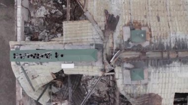 This stock vertical video shows a war-torn building in Stoyanka, Bucha district, Ukraine, flat, grey video