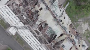 This stock vertical video shows a war-torn building in Stoyanka, Bucha district, Ukraine, flat, grey video