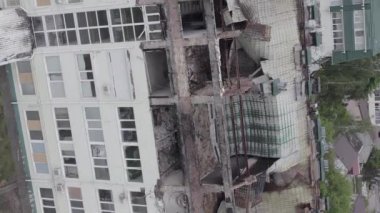 This stock vertical video shows a war-torn building in Stoyanka, Bucha district, Ukraine, flat, grey video