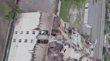 This stock vertical video shows a war-torn building in Stoyanka, Bucha district, Ukraine, flat, grey video