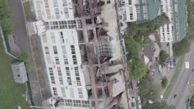 This stock vertical video shows a war-torn building in Stoyanka, Bucha district, Ukraine, flat, grey video