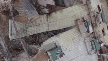 This stock vertical video shows a war-torn building in Stoyanka, Bucha district, Ukraine, flat, grey video