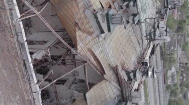 This stock vertical video shows a war-torn building in Stoyanka, Bucha district, Ukraine, flat, grey video