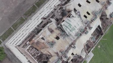 This stock vertical video shows a war-torn building in Stoyanka, Bucha district, Ukraine, flat, grey video