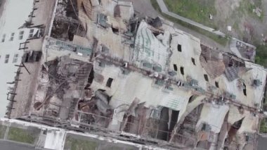 This stock vertical video shows a war-torn building in Stoyanka, Bucha district, Ukraine, flat, grey video