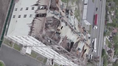 This stock vertical video shows a war-torn building in Stoyanka, Bucha district, Ukraine, flat, grey video