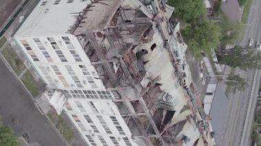 This stock vertical video shows a war-torn building in Stoyanka, Bucha district, Ukraine, flat, grey video