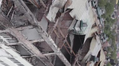 This stock vertical video shows a war-torn building in Stoyanka, Bucha district, Ukraine, flat, grey video