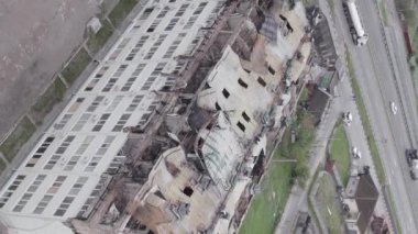 This stock vertical video shows a war-torn building in Stoyanka, Bucha district, Ukraine, flat, grey video