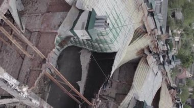 This stock vertical video shows a war-torn building in Stoyanka, Bucha district, Ukraine, flat, grey video